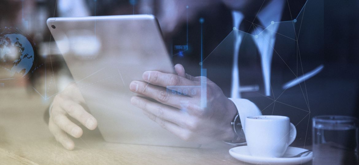 Businessman working on tablet in cafe